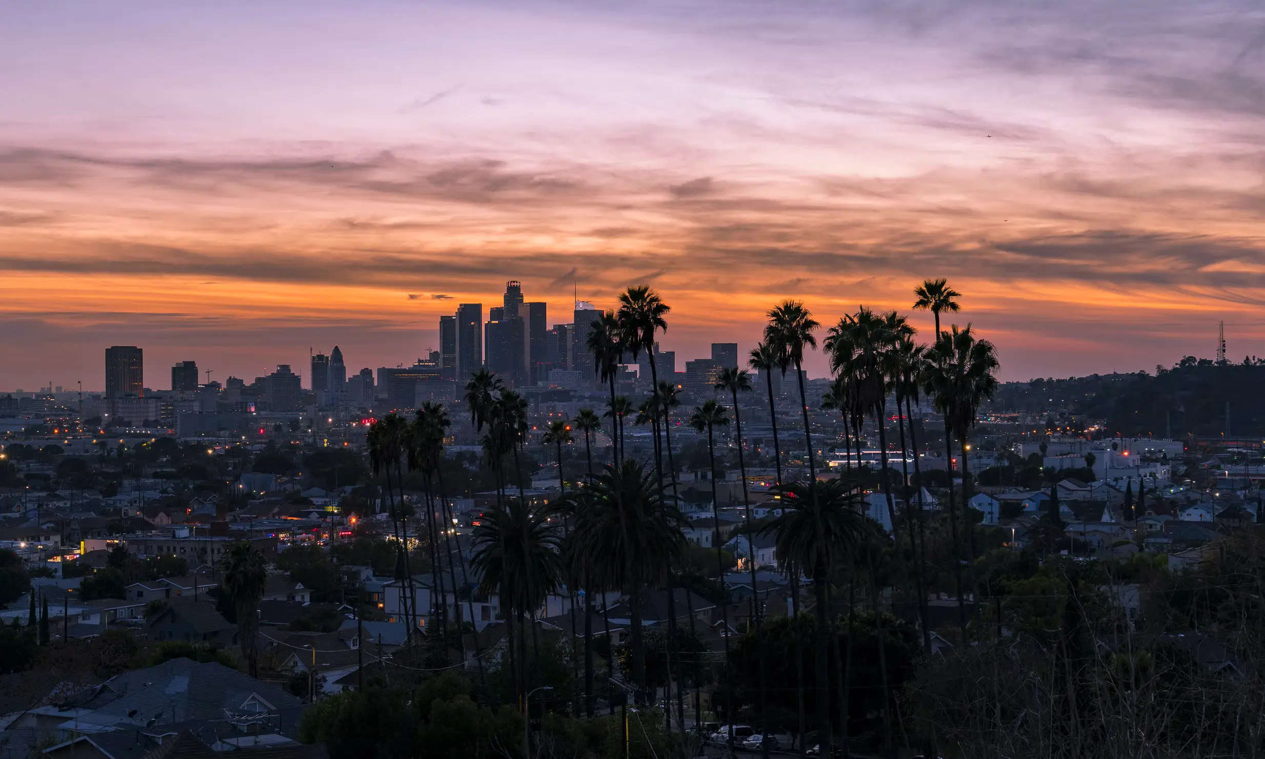 Backdrop of Los Angeles at sunset with quote from Anais Nin